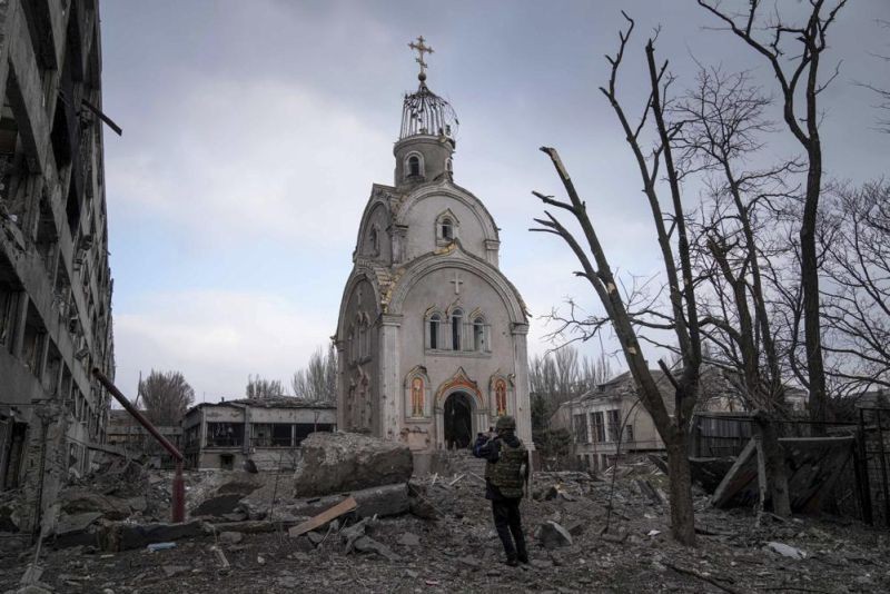 A Ukrainian serviceman takes a photograph of a damaged church after shelling in a residential district in Mariupol, Ukraine, Thursday, March 10, 2022. (AP Photo)